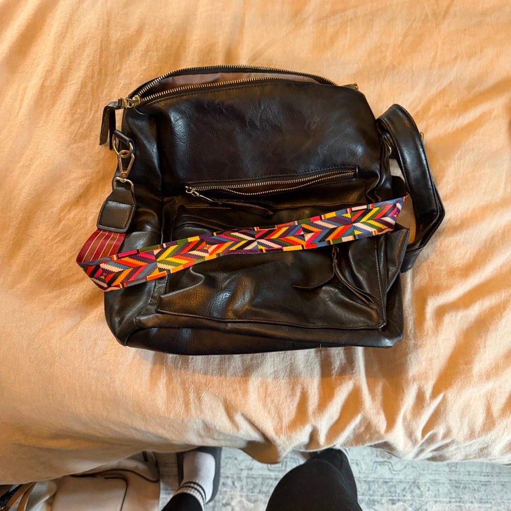 Chic Black Leather Women's Backpack with Vibrant Strap